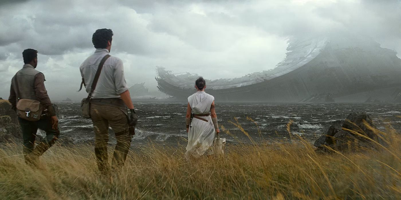 Finn, Poe, and Rey stand on a cliff observing the ruins of the old Death Star, several kilometres out to sea.