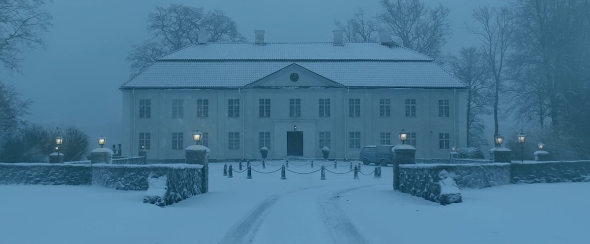 An enormous white mansion at twilight, under a heavy blanket of snow. The image is from David Fincher's film of "The Girl With The Dragon Tattoo."